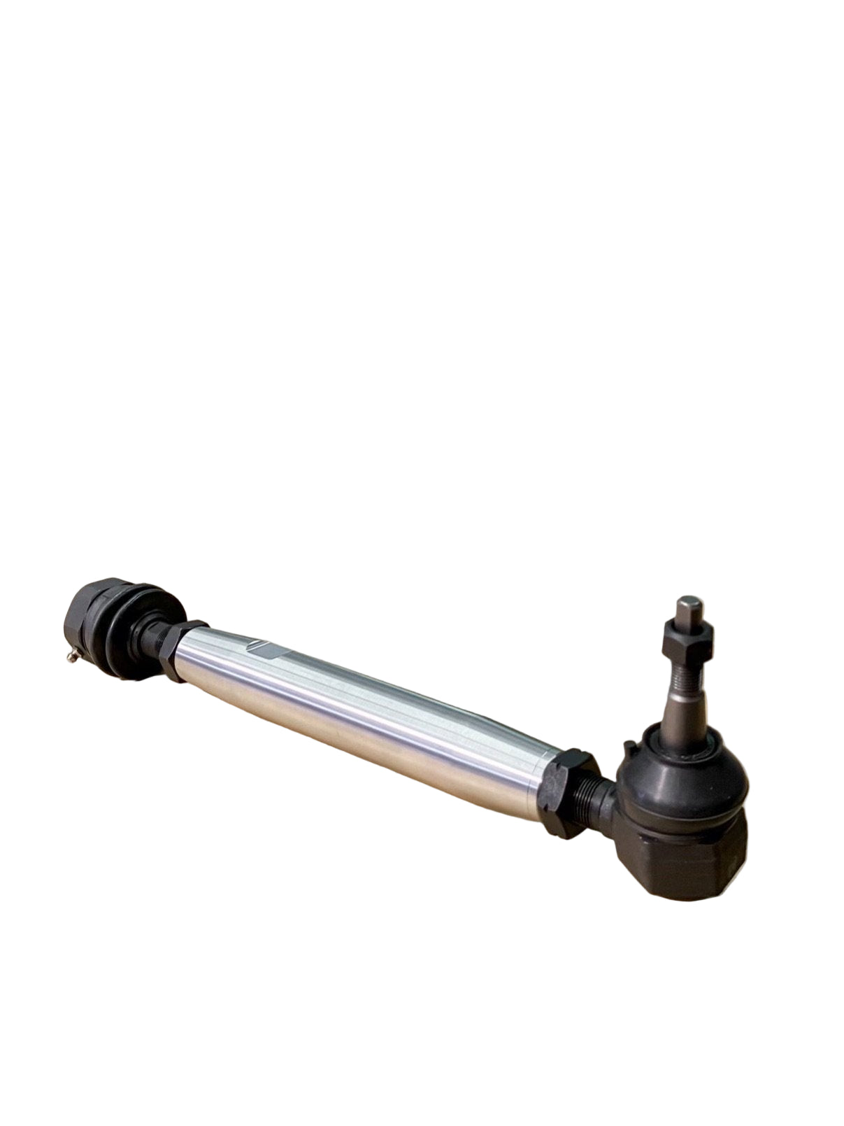 A CNC machined tie rod kit positioned on a wooden surface with a industrial machine in the background, presumably part of the production process.