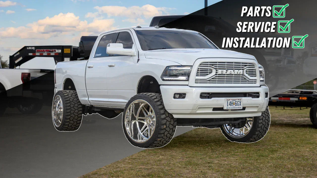Lifted white Ram truck with large off-road tires, chrome wheels, and text: Parts, Service, Installation