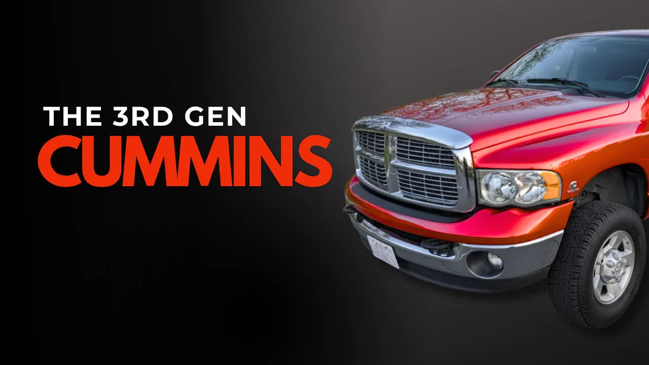 Red third generation Dodge Ram Cummins truck with bold front grille on dark background