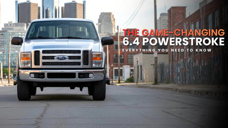 Front view of a Ford Super Duty truck with 6.4 Powerstroke engine parked on an urban street.