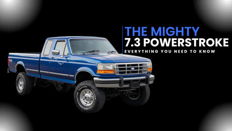 Blue lifted Ford truck with 'The Mighty 7.3 Powerstroke' text on black background