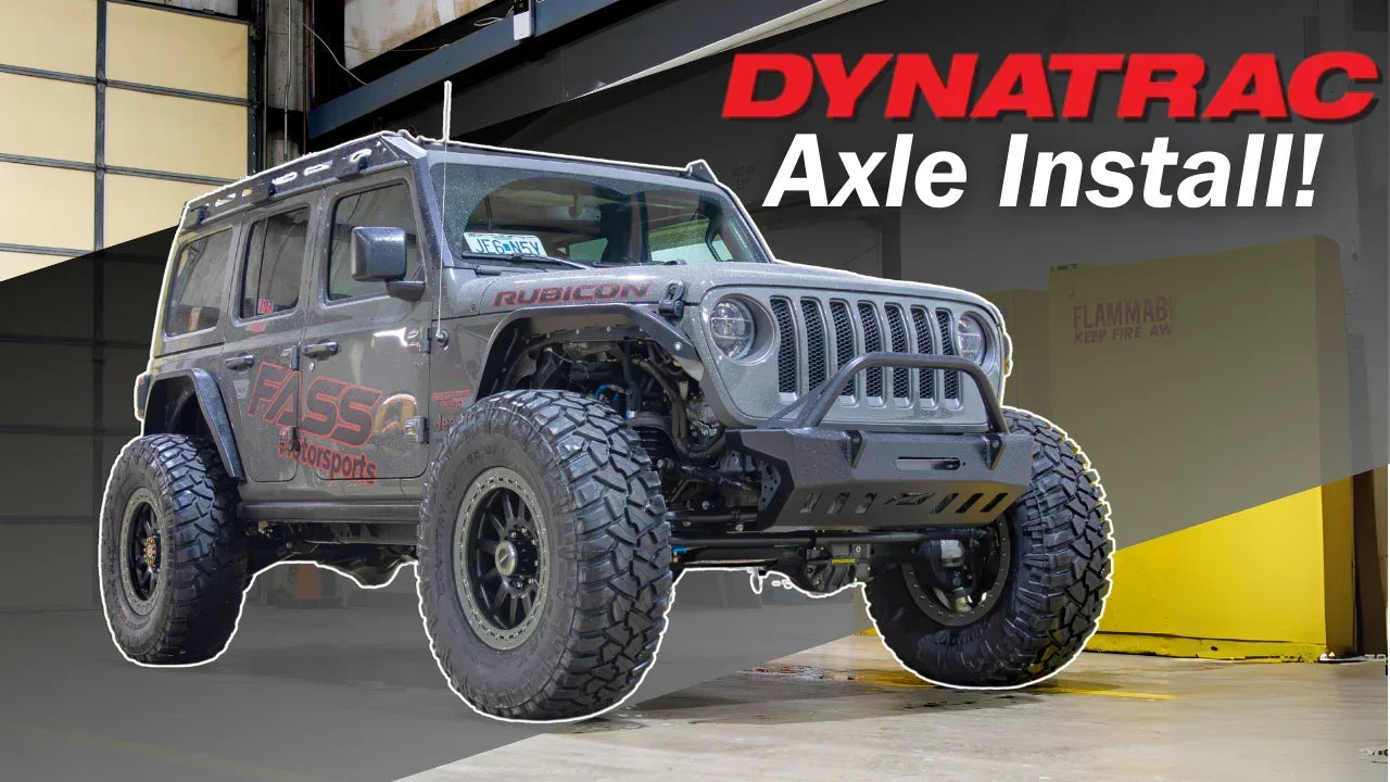 Lifted Jeep Wrangler Rubicon in a garage, showcasing Dynatrac axle installation.