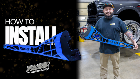 Man holding blue FASS radius arm upgrade for 2014 Ram 2500/3500 truck in garage