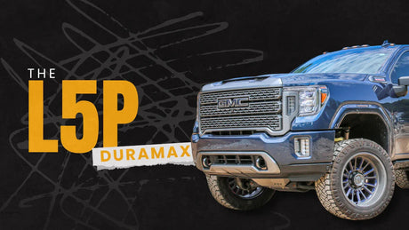 Front view of a lifted GMC L5P Duramax truck on rugged tires with bold text overlay.