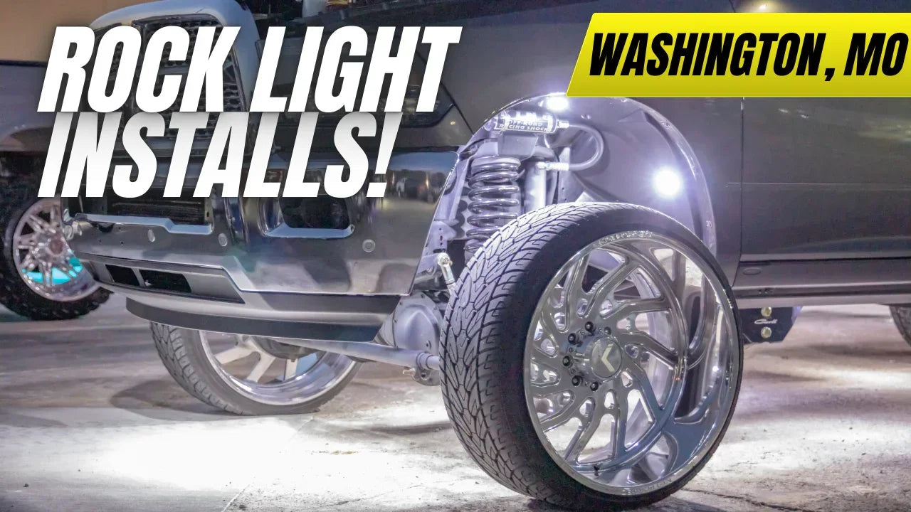Truck with large chrome wheels and bright LED rock lights installed in Washington, MO garage