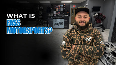 Man in camo hoodie with arms crossed at off-road truck and Jeep parts store counter