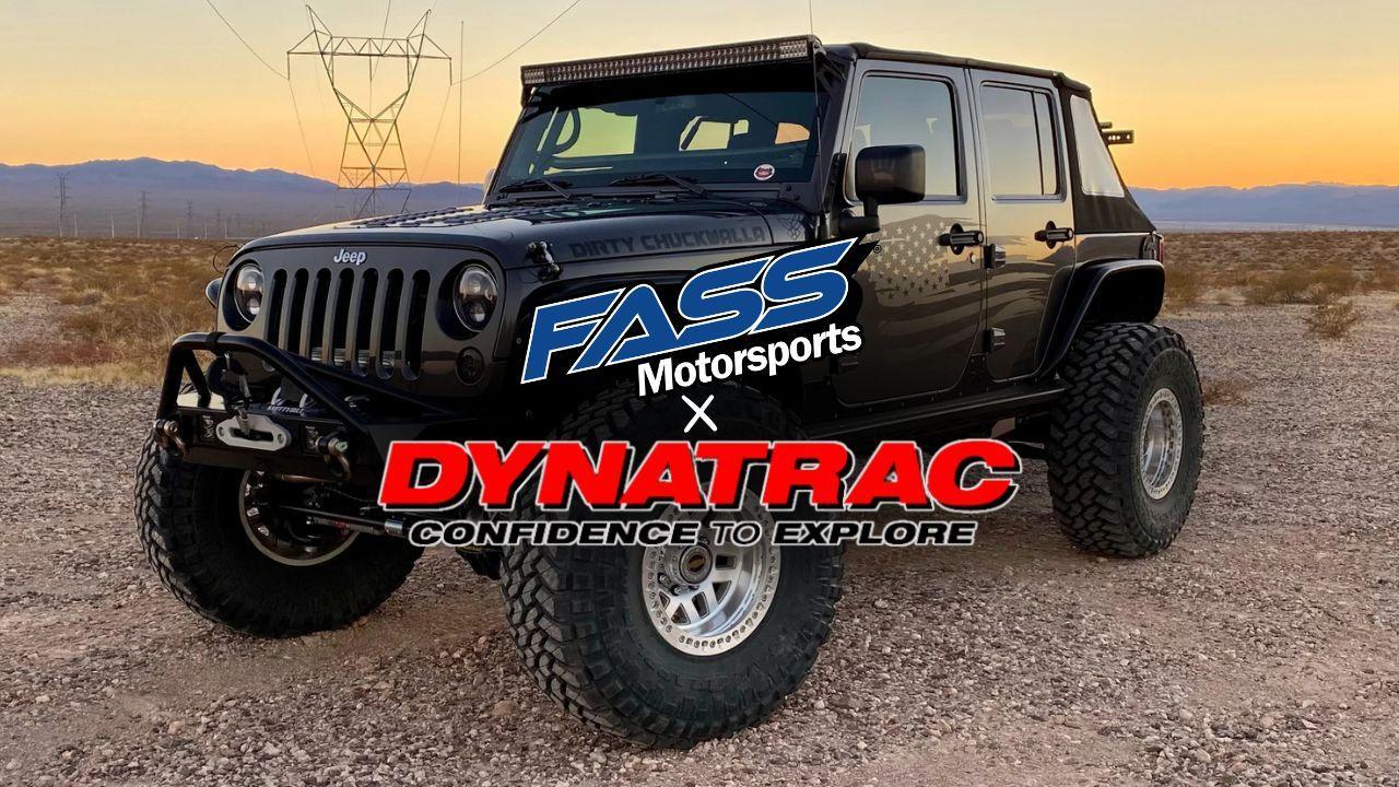 Lifted off-road Jeep Wrangler with FASS Motorsports and Dynatrac branding in desert at sunset