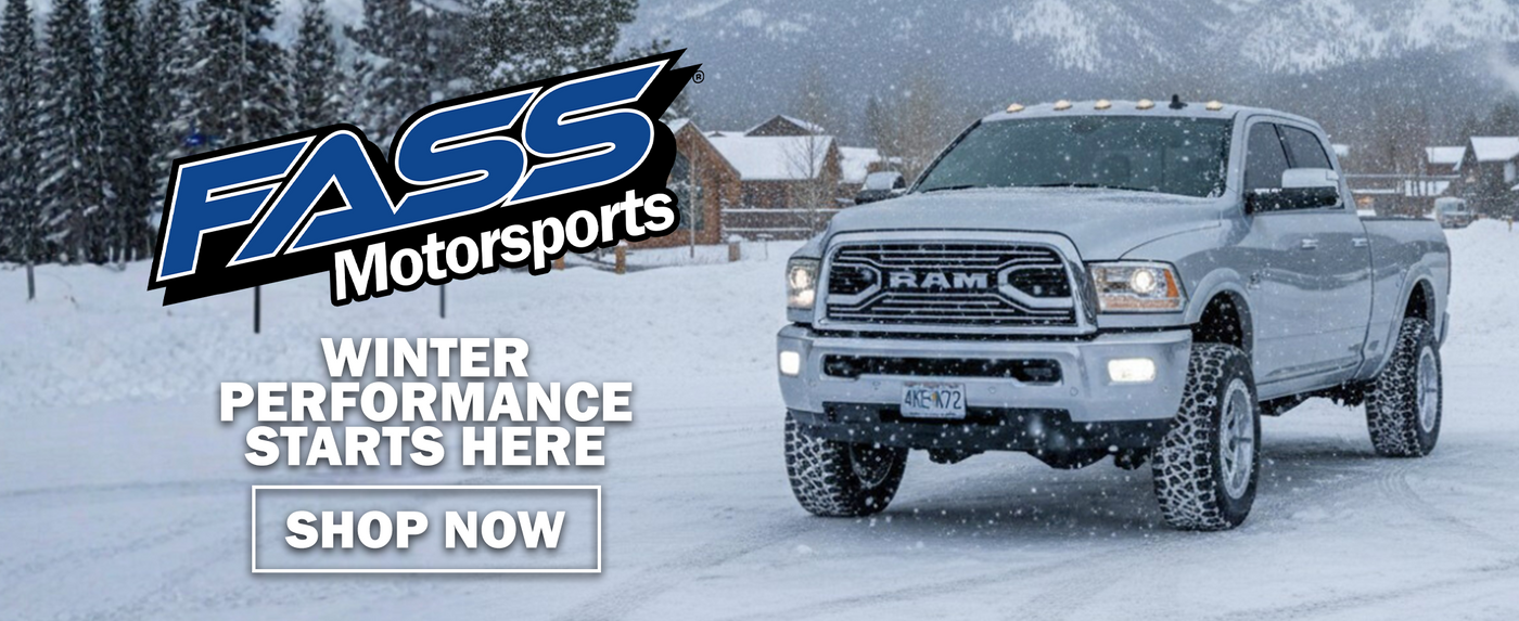 Silver Ram truck in a snowy landscape with FASS Motorsports branding.