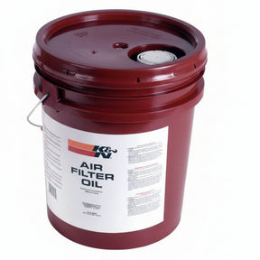 A 5-gallon red bucket labeled 'K&N Air Filter Oil', indicating its use for air filter maintenance.
